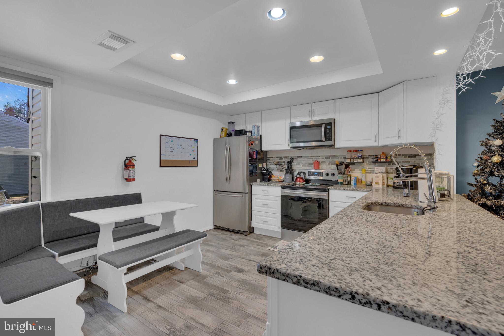 1802 Bromley Estate Pine Hill, NJ 08021 - Photo 7 of 26 a kitchen with granite countertop a refrigerator stove top oven and sink