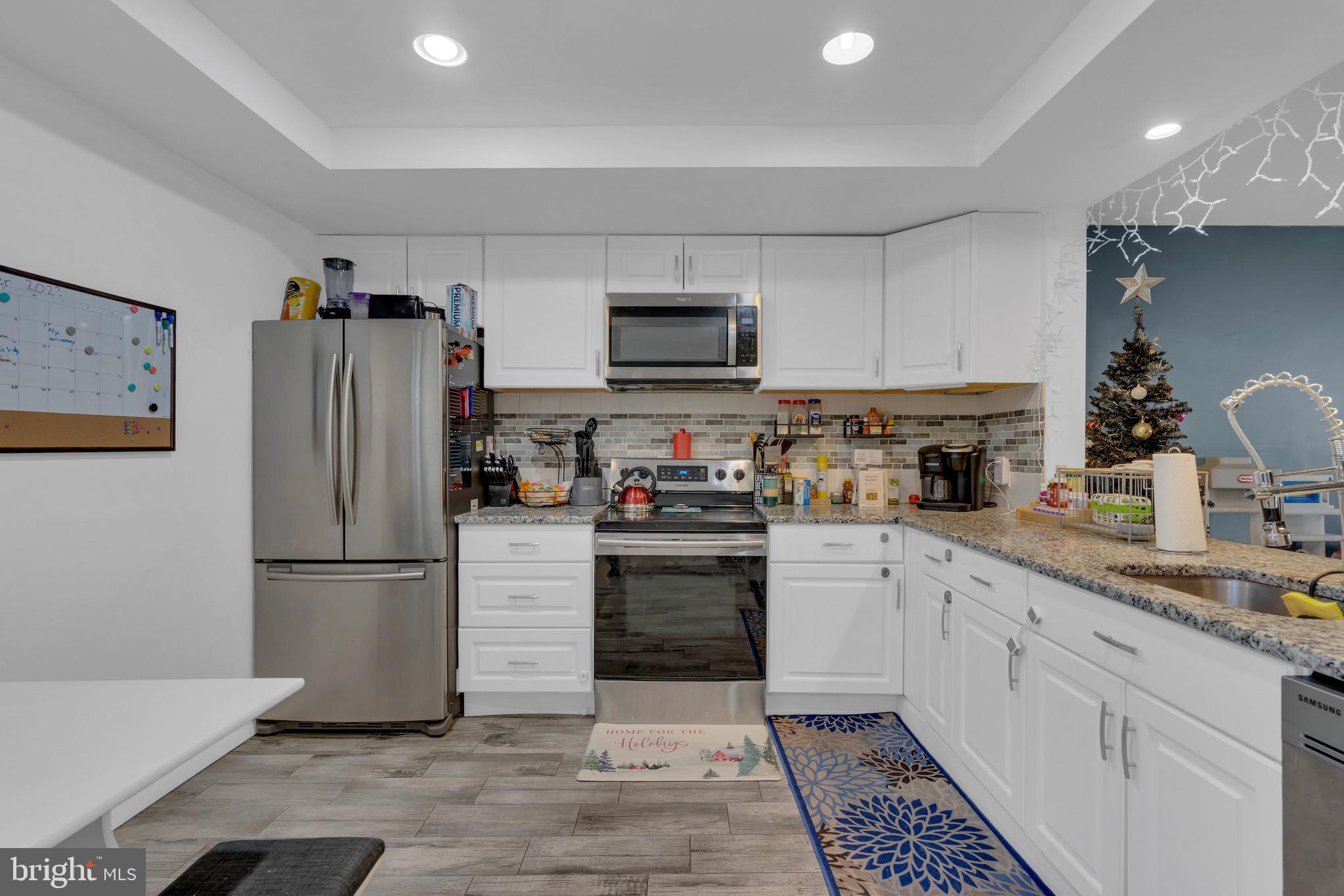 1802 Bromley Estate Pine Hill, NJ 08021 - Photo 8 of 26 a kitchen with granite countertop a refrigerator and a stove top oven