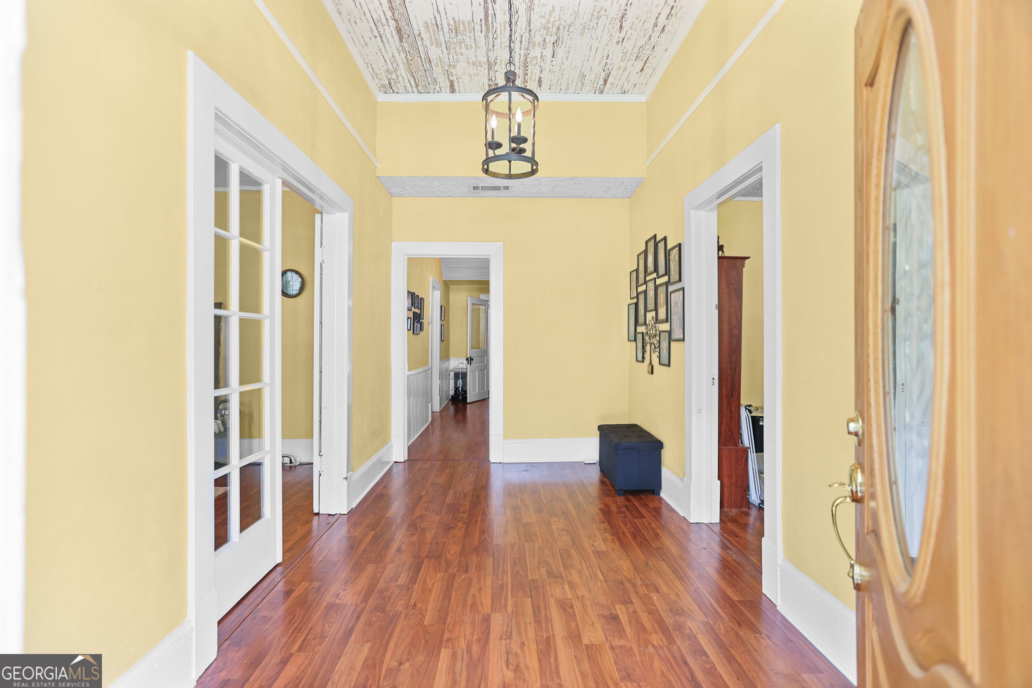 1205 Terrell Street Greenville, GA 30222 - Photo 6 of 50 a hallway with wooden floor chandelier and livingroom