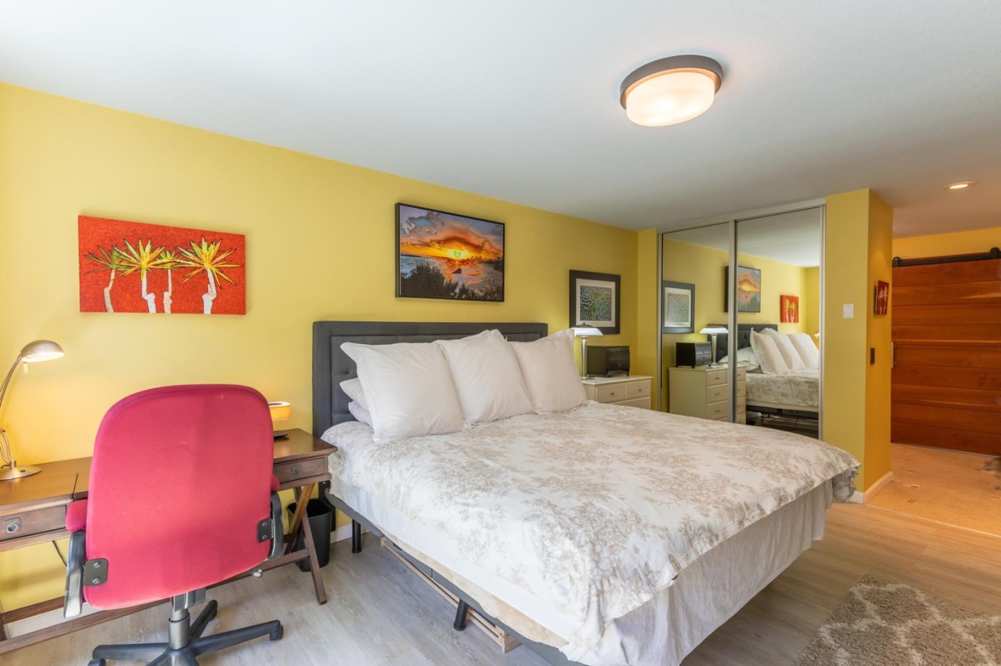 47 Shepherds Knoll Road, Unit 47 Monterey, CA 93940 - Photo 34 of 46 a spacious bedroom with a bed a table and painting on the wall