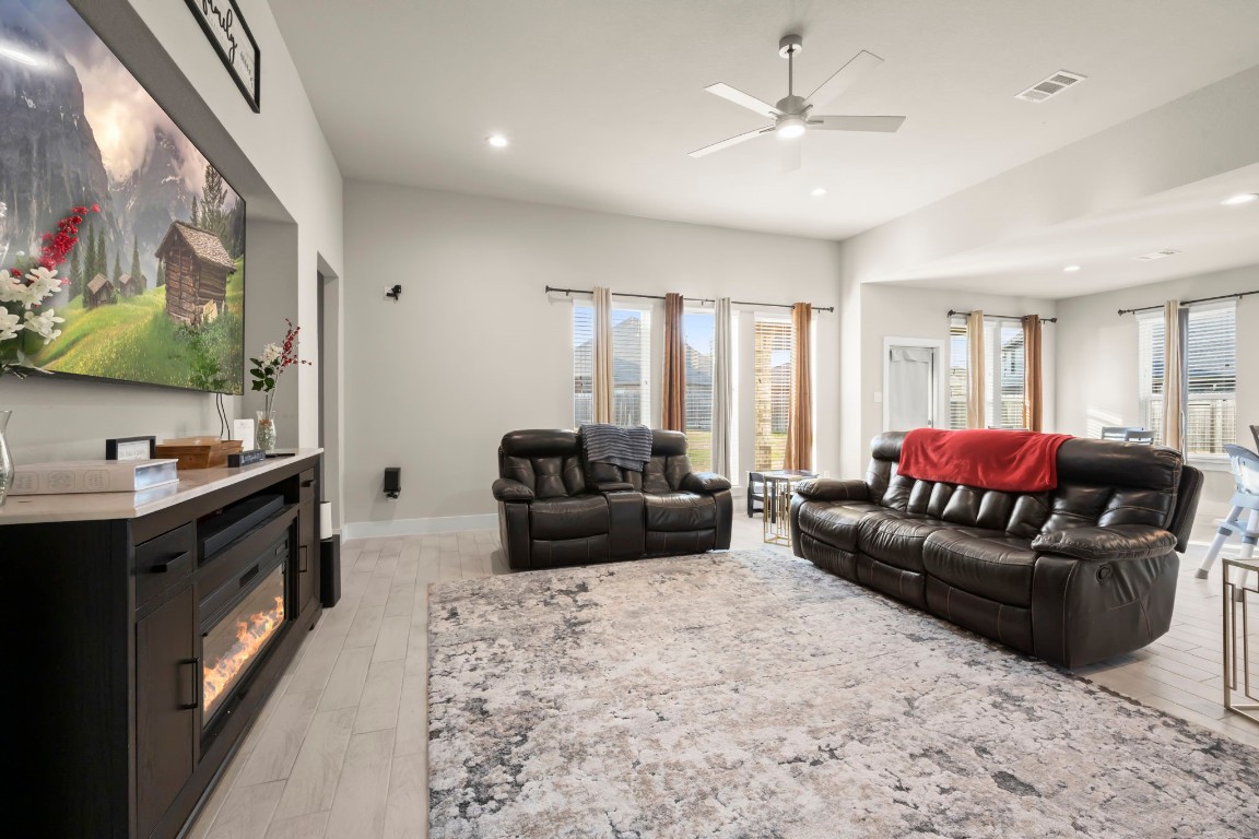 24715 Native Forest Spring, TX 77373 - Photo 17 of 37 a living room with furniture a flat screen tv and a couch