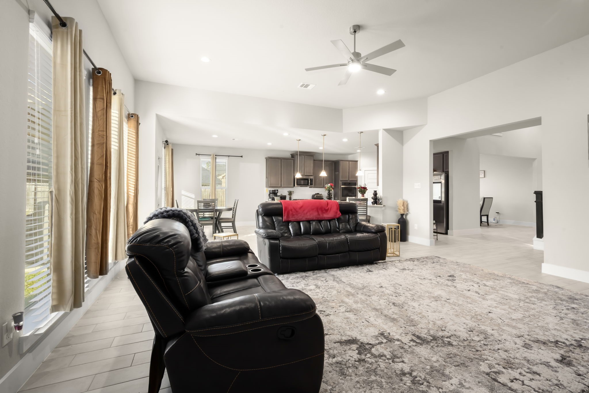 24715 Native Forest Spring, TX 77373 - Photo 18 of 37 This spacious, open-concept living area features ample natural light, modern finishes, and a seamless flow into the kitchen and dining space. Ideal for entertaining, with a cozy seating arrangement and stylish decor.