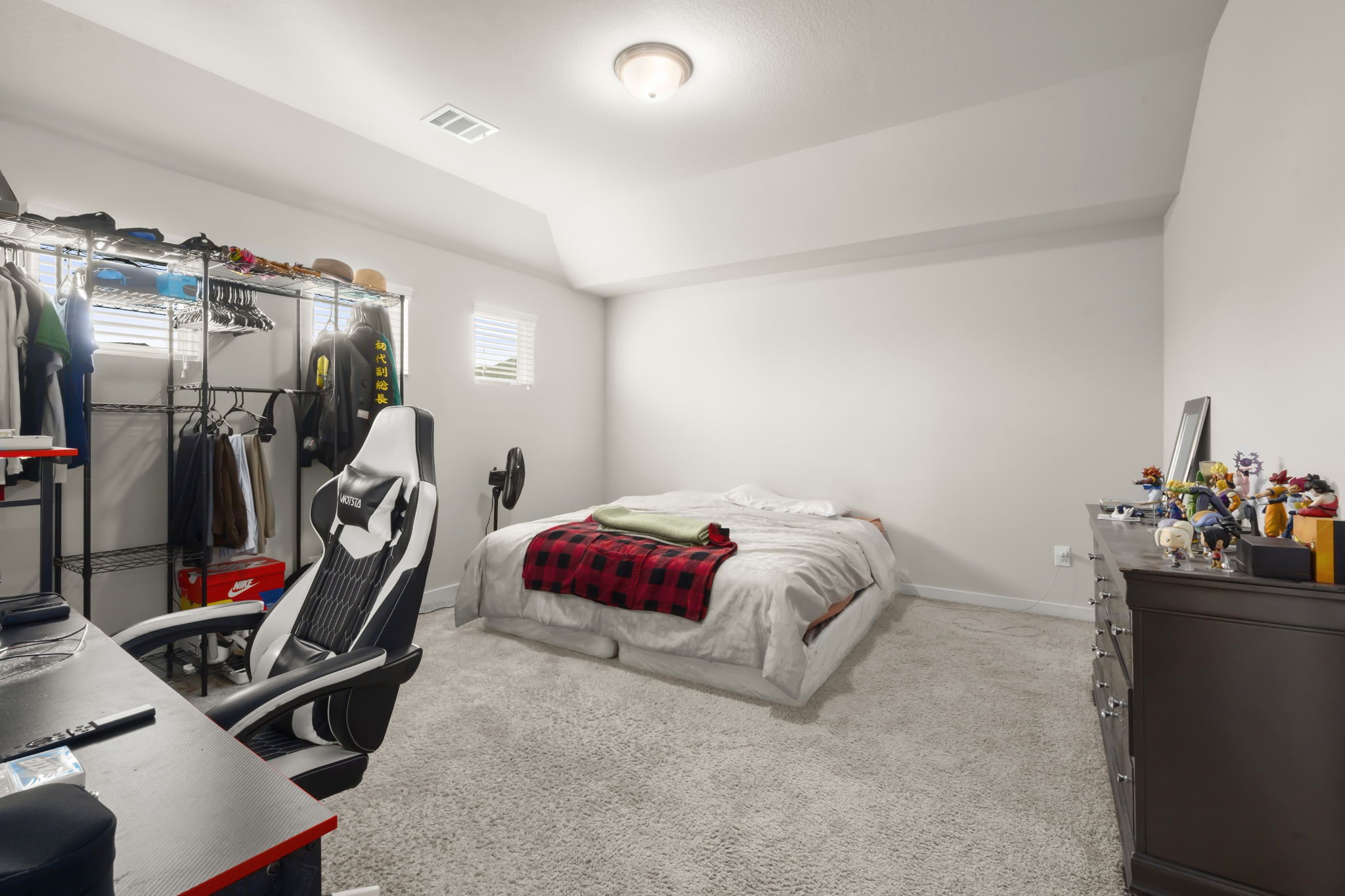 24715 Native Forest Spring, TX 77373 - Photo 28 of 37 This cozy bedroom features soft carpeting, ideal for work or leisure. The room is illuminated by a ceiling light and a small window.