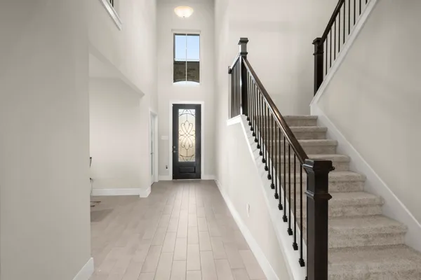 a view of a livingroom with wooden floor and stairs