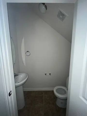 a white toilet sitting in a bathroom