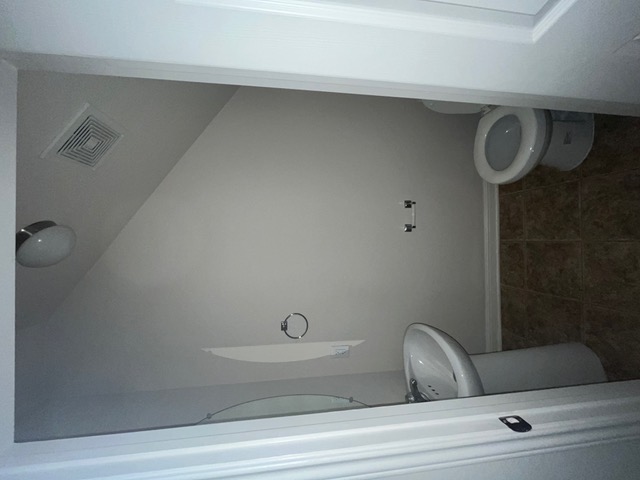 5425 Falling Leaf Lane Austin, TX 78744 - Photo 12 of 28 a white toilet sitting in a bathroom