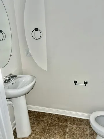 a bathroom with a sink mirror toilet and vanity