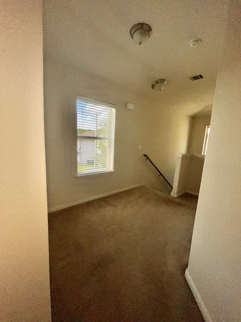 5425 Falling Leaf Lane Austin, TX 78744 - Photo 14 of 28 an empty room with a empty space and windows
