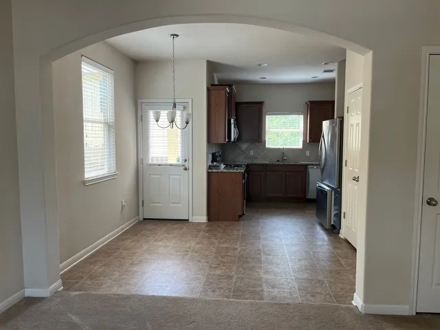 a view of a big room with windows and cabinet