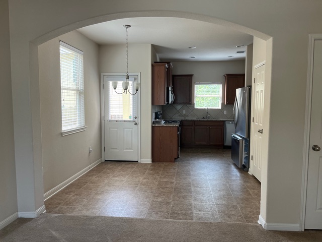 5425 Falling Leaf Lane Austin, TX 78744 - Photo 7 of 28 a view of a big room with windows and cabinet