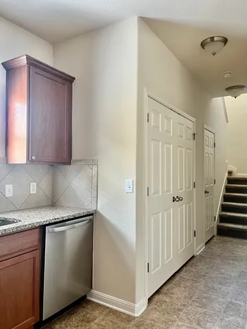 a kitchen with granite countertop cabinets and steel stainless steel appliances