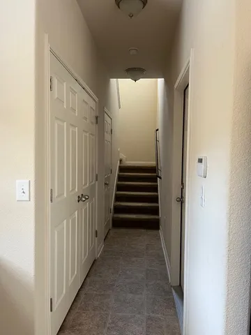 a view of a hallway with stairs and entryway