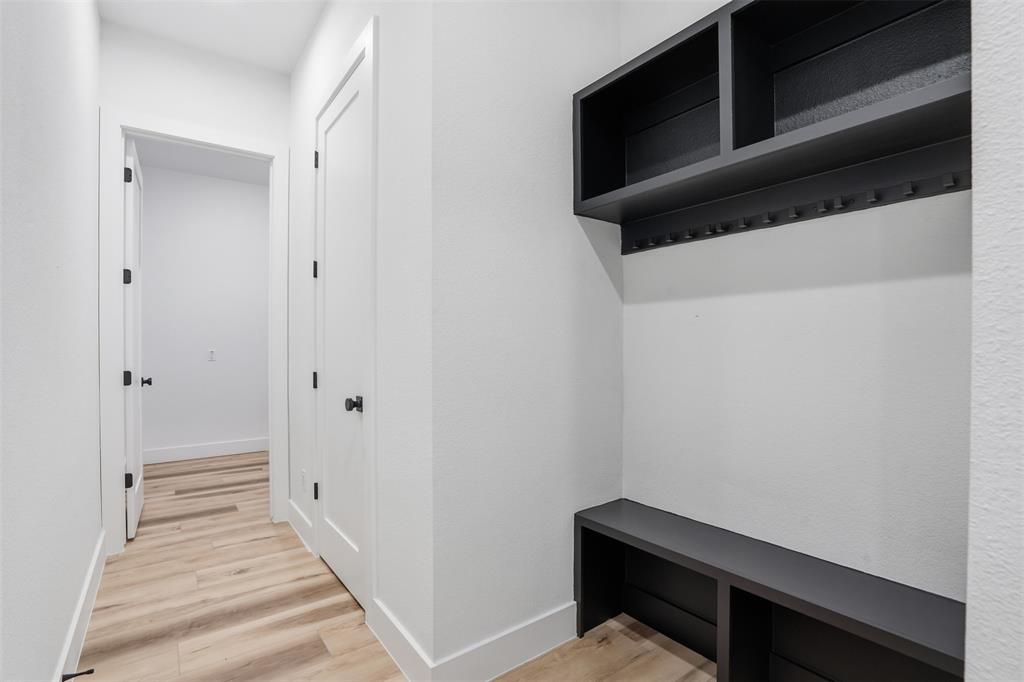 1111 Riverwood Road Dallas, TX 75217 - Photo 28 of 40 Built-in organizational system featuring dark shelving, storage cubbies, and coat hooks