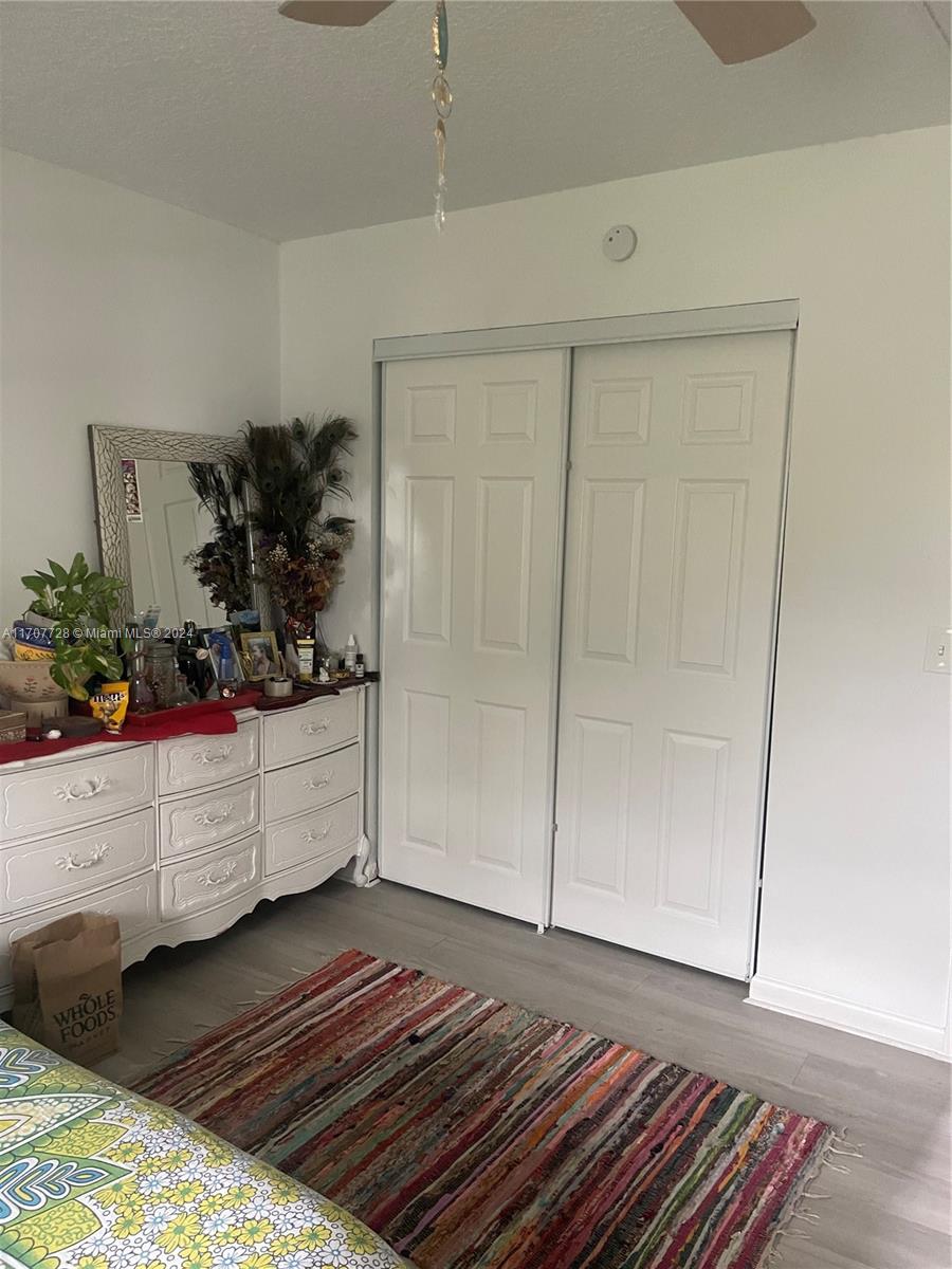 191 Prescott J, Unit 191 Deerfield Beach, FL 33442 - Photo 11 of 18 a room with wooden floor