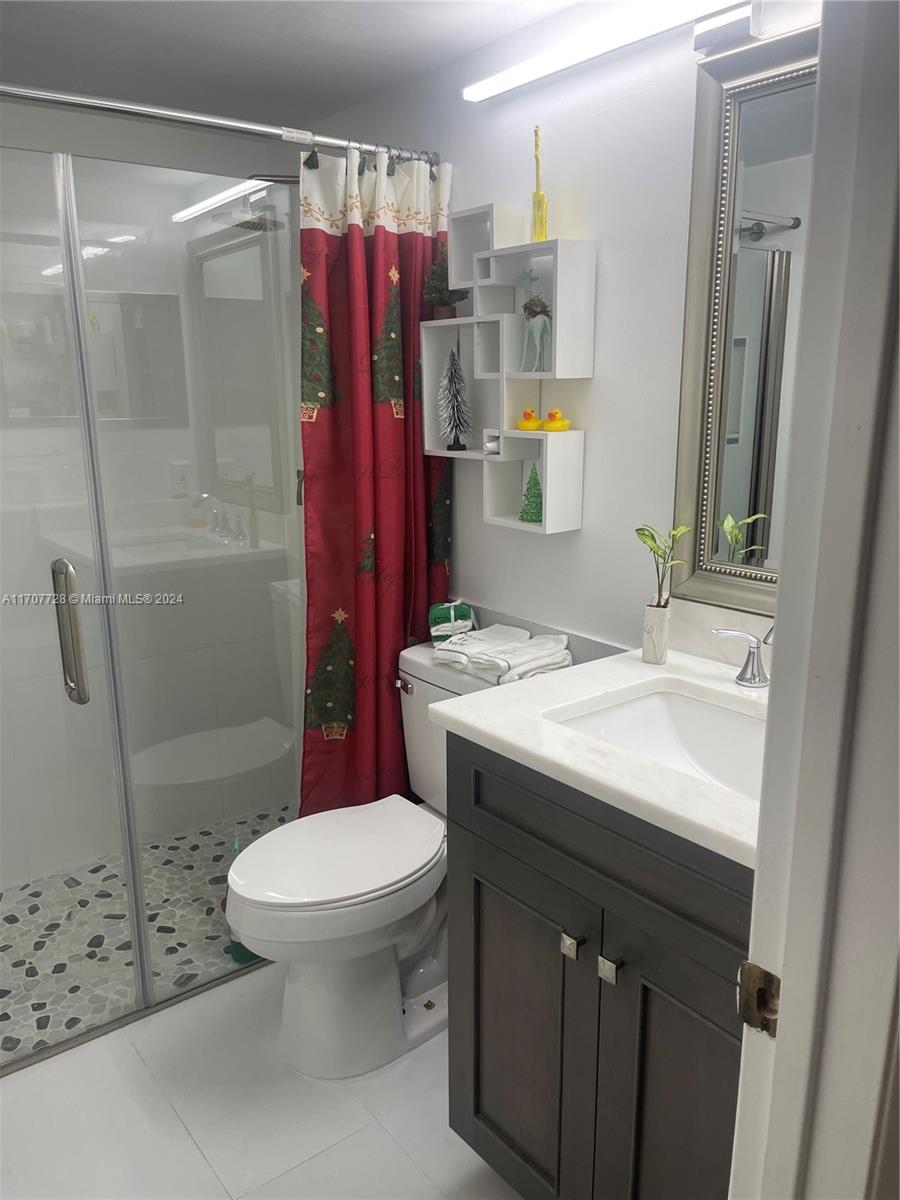 191 Prescott J, Unit 191 Deerfield Beach, FL 33442 - Photo 13 of 18 a bathroom with a sink a toilet and shower