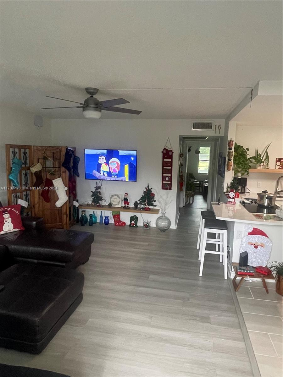 191 Prescott J, Unit 191 Deerfield Beach, FL 33442 - Photo 18 of 18 a living room with furniture and a flat screen tv