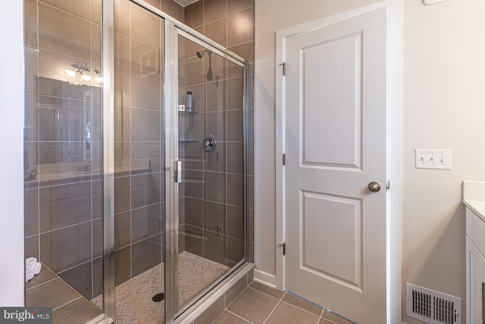 20975 Bluebird Square Sterling, VA 20165 - Photo 6 of 23 a bathroom with a glass shower door