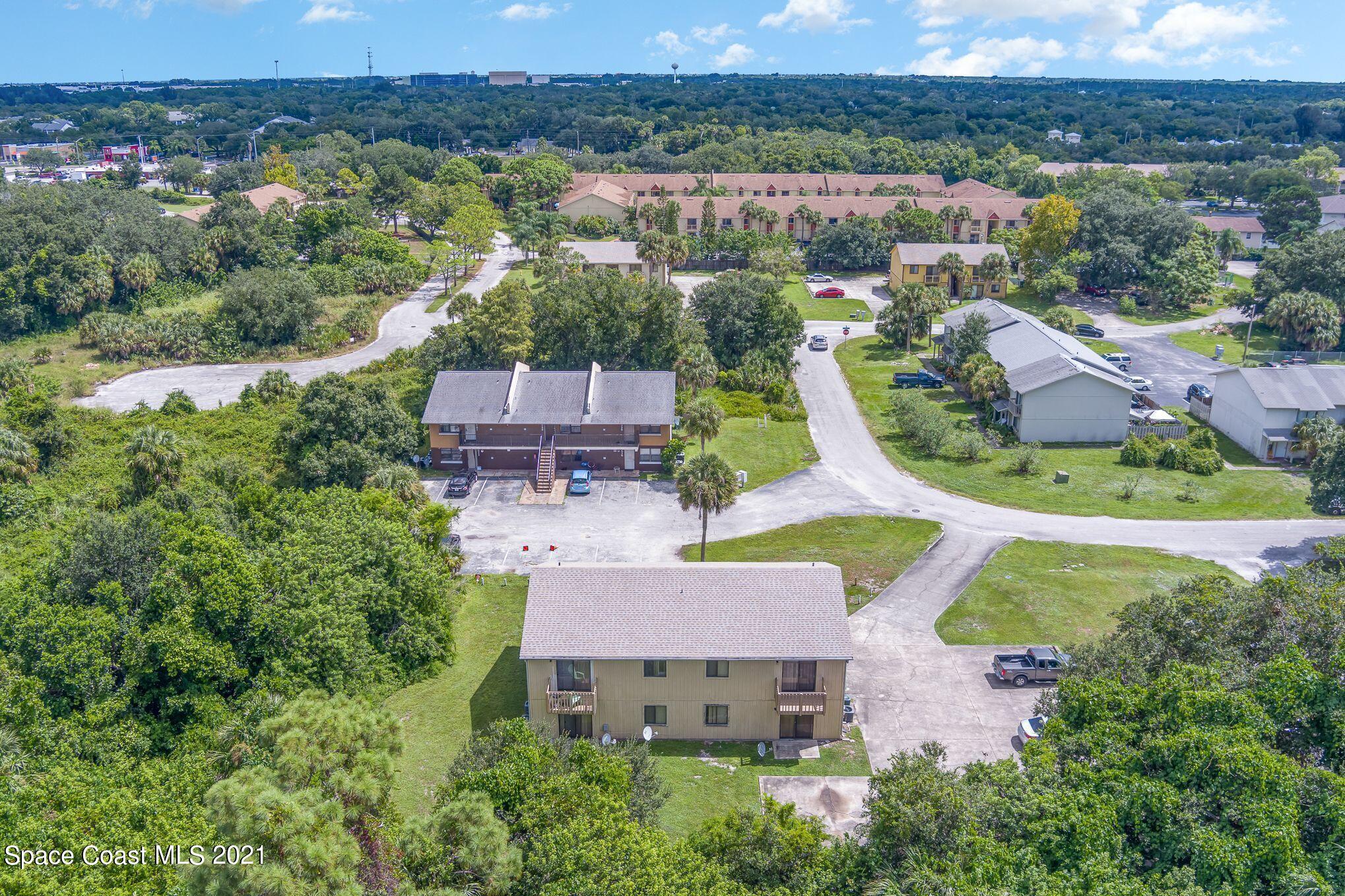 4313 Tree Ridge Lane Northeast Palm Bay, FL 32905 - Photo 5 of 9 an aerial view of a house with garden space and a mountain