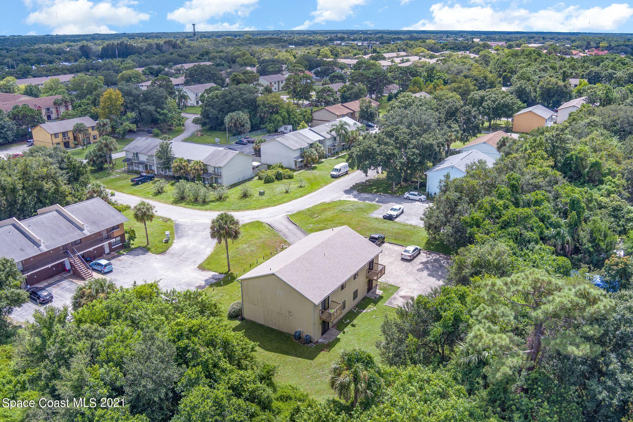 4313 Tree Ridge Lane Northeast Palm Bay, FL 32905 - Photo 6 of 9 an aerial view of a house with yard swimming pool and outdoor seating