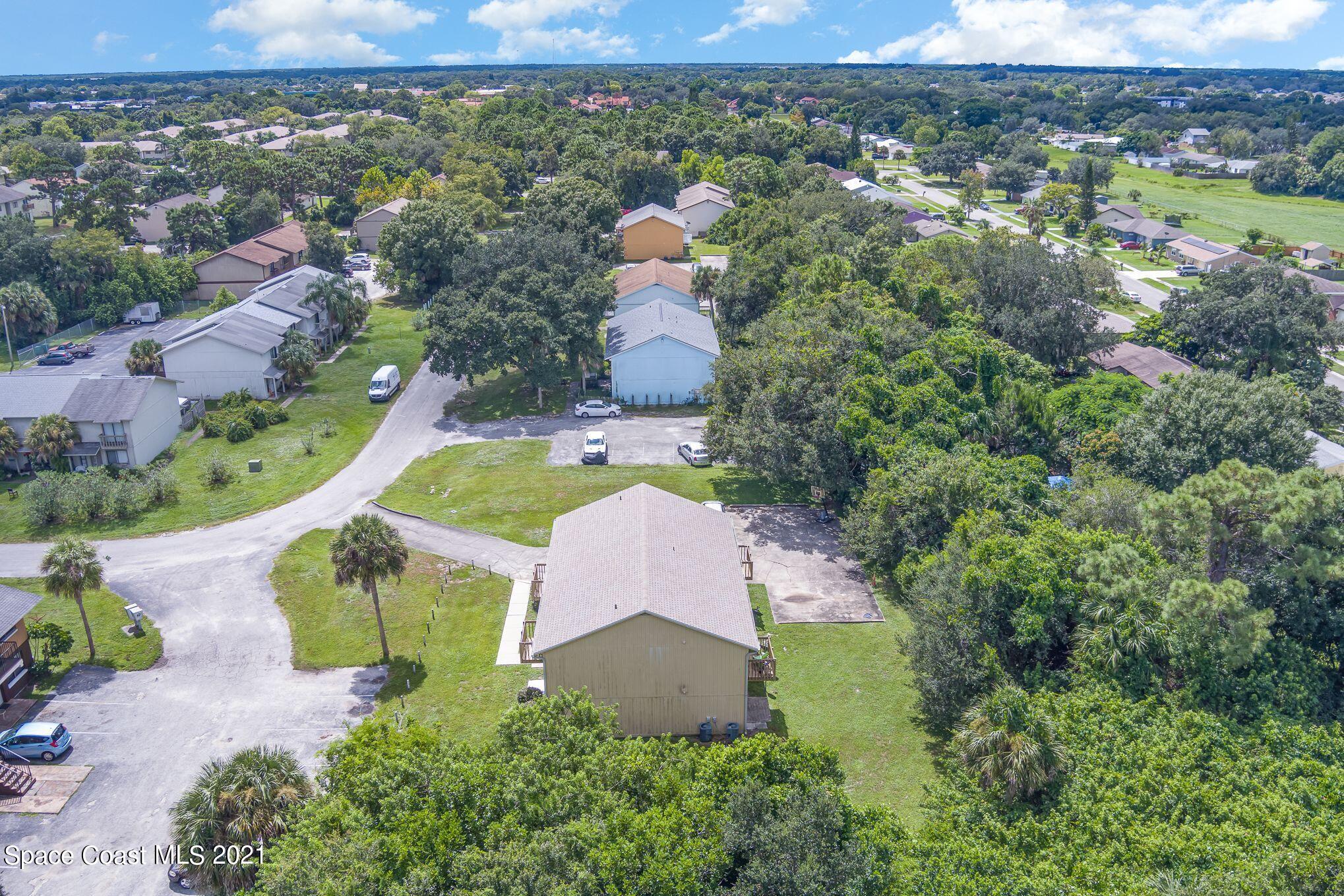4313 Tree Ridge Lane Northeast Palm Bay, FL 32905 - Photo 7 of 9 an aerial view of a house with a swimming pool yard and outdoor seating