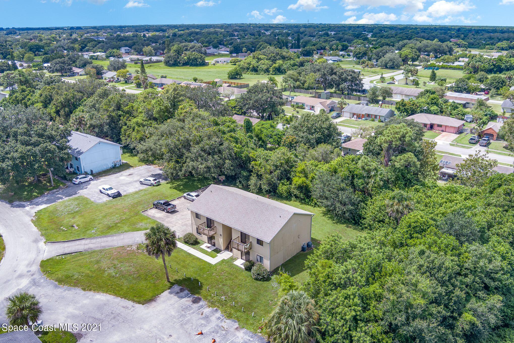 4313 Tree Ridge Lane Northeast Palm Bay, FL 32905 - Photo 8 of 9 an aerial view of a house with yard