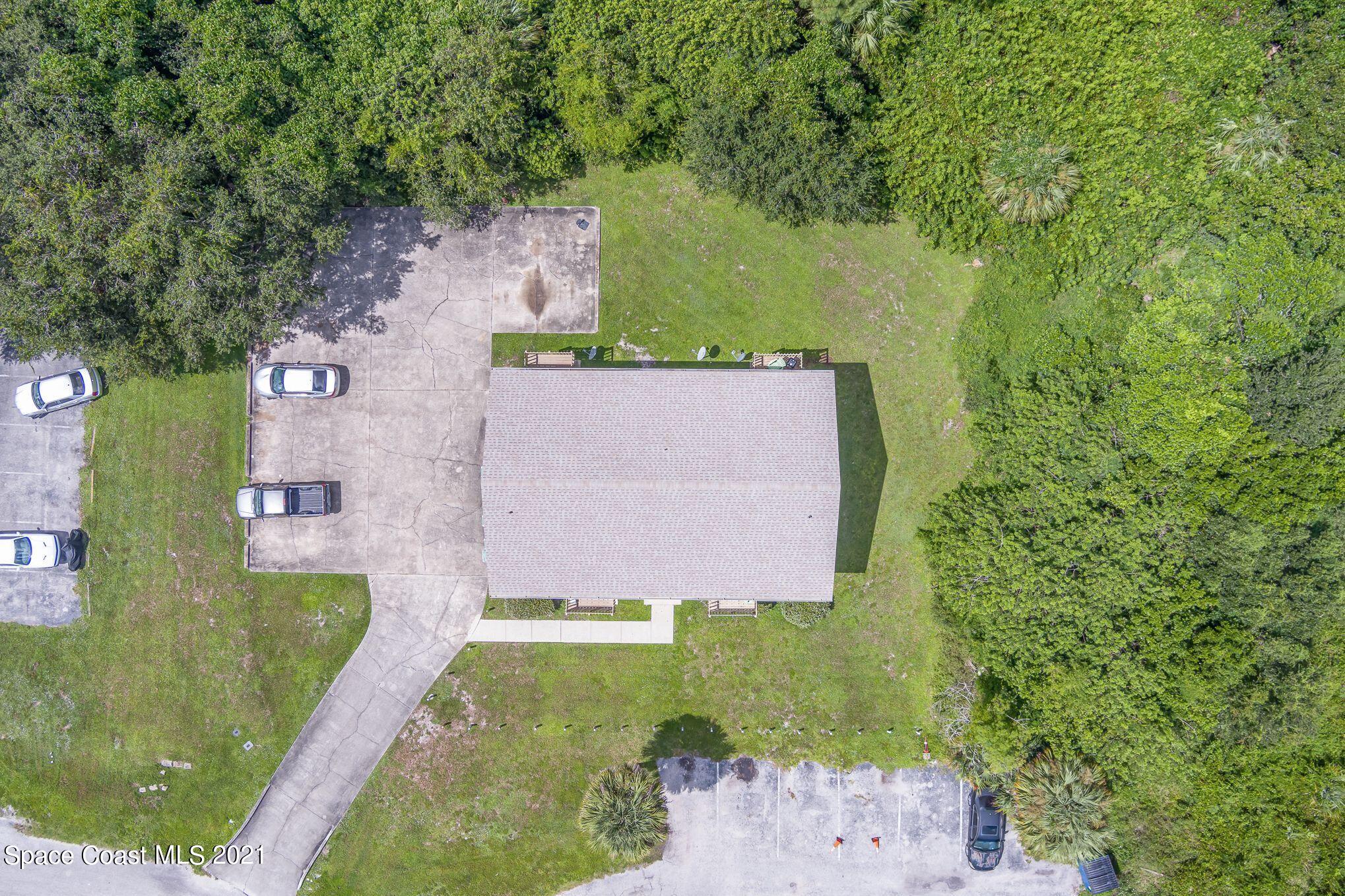 4313 Tree Ridge Lane Northeast Palm Bay, FL 32905 - Photo 9 of 9 an aerial view of a house