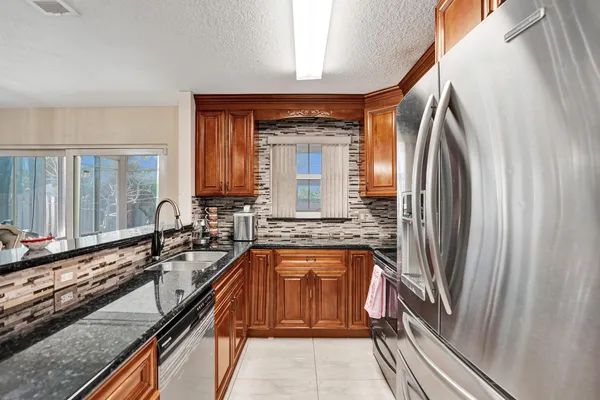 a view of a kitchen with a sink and dishwasher