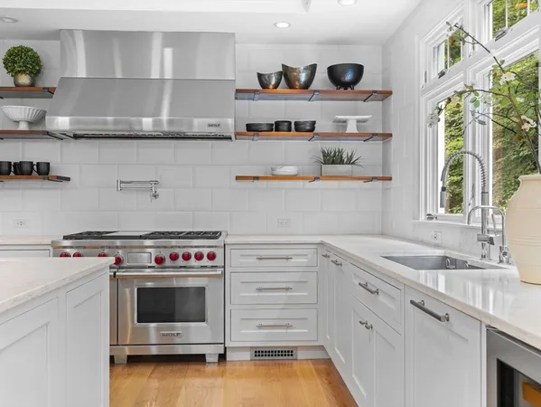 a kitchen with granite countertop a stove and a wooden floor