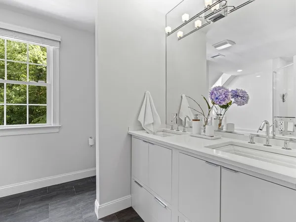 a bathroom with a sink vanity and a mirror