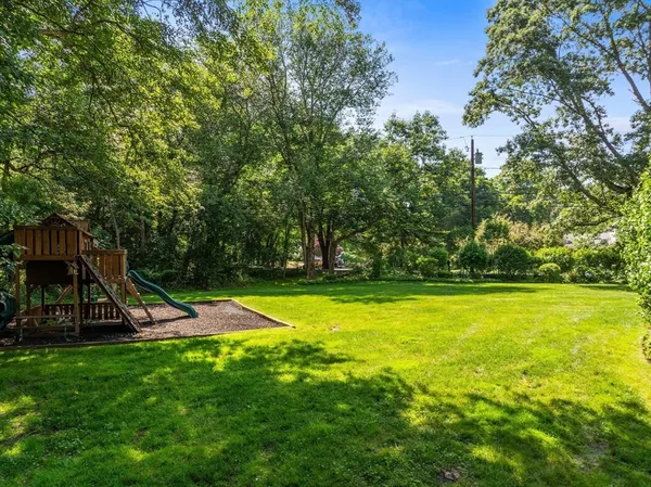 a view of a swimming pool with a bench and trees
