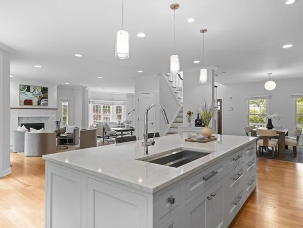 a kitchen with center island a sink stainless steel appliances and dining table