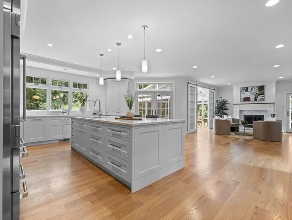 a kitchen with kitchen island a large counter top space and stainless steel appliances