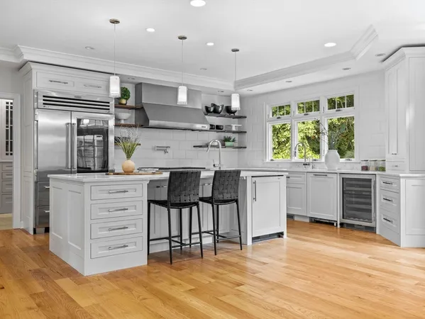 a kitchen with stainless steel appliances a stove a sink and a refrigerator