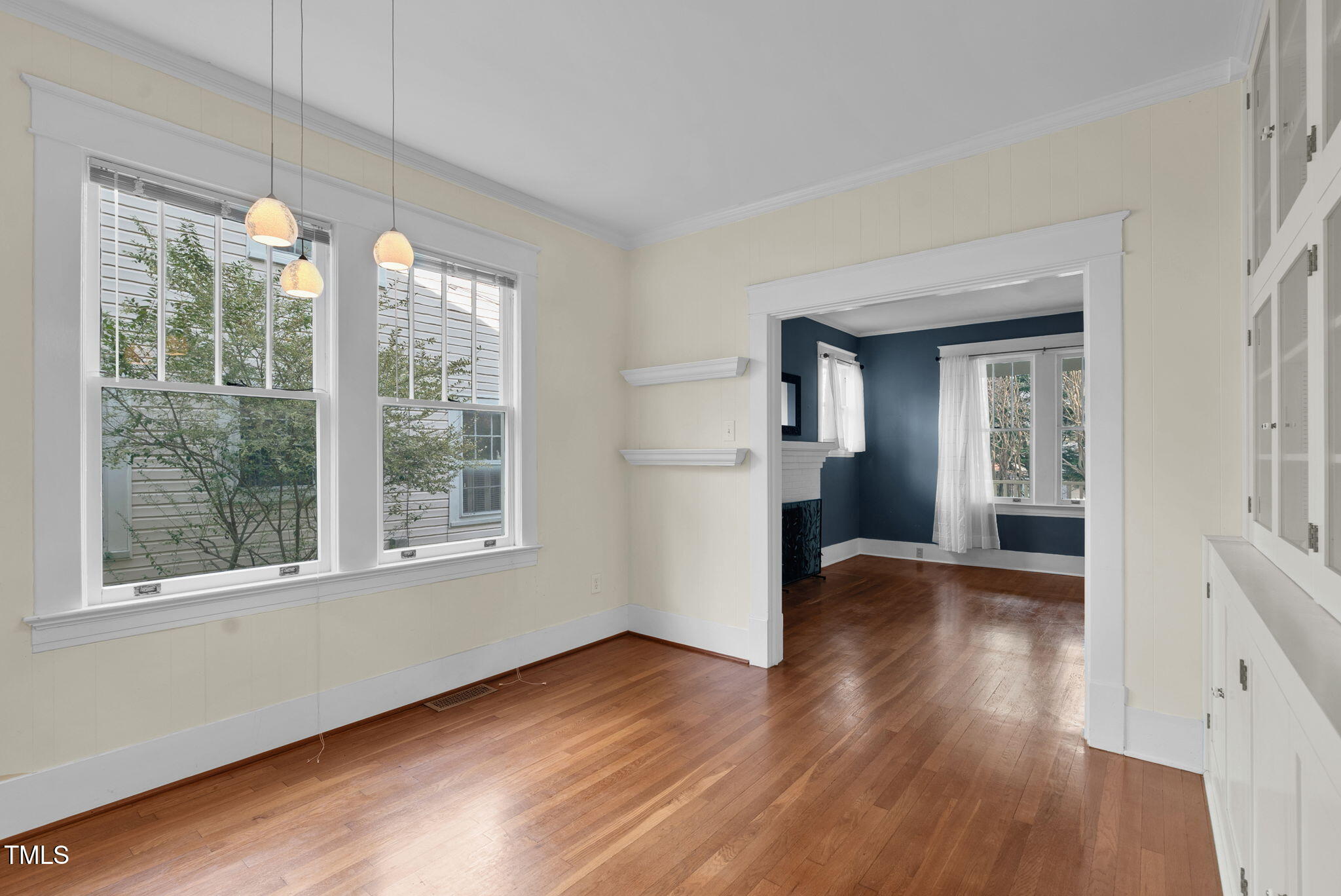 306 Perry Street Raleigh, NC 27608 - Photo 12 of 48 a view of an empty room with wooden floor and a window