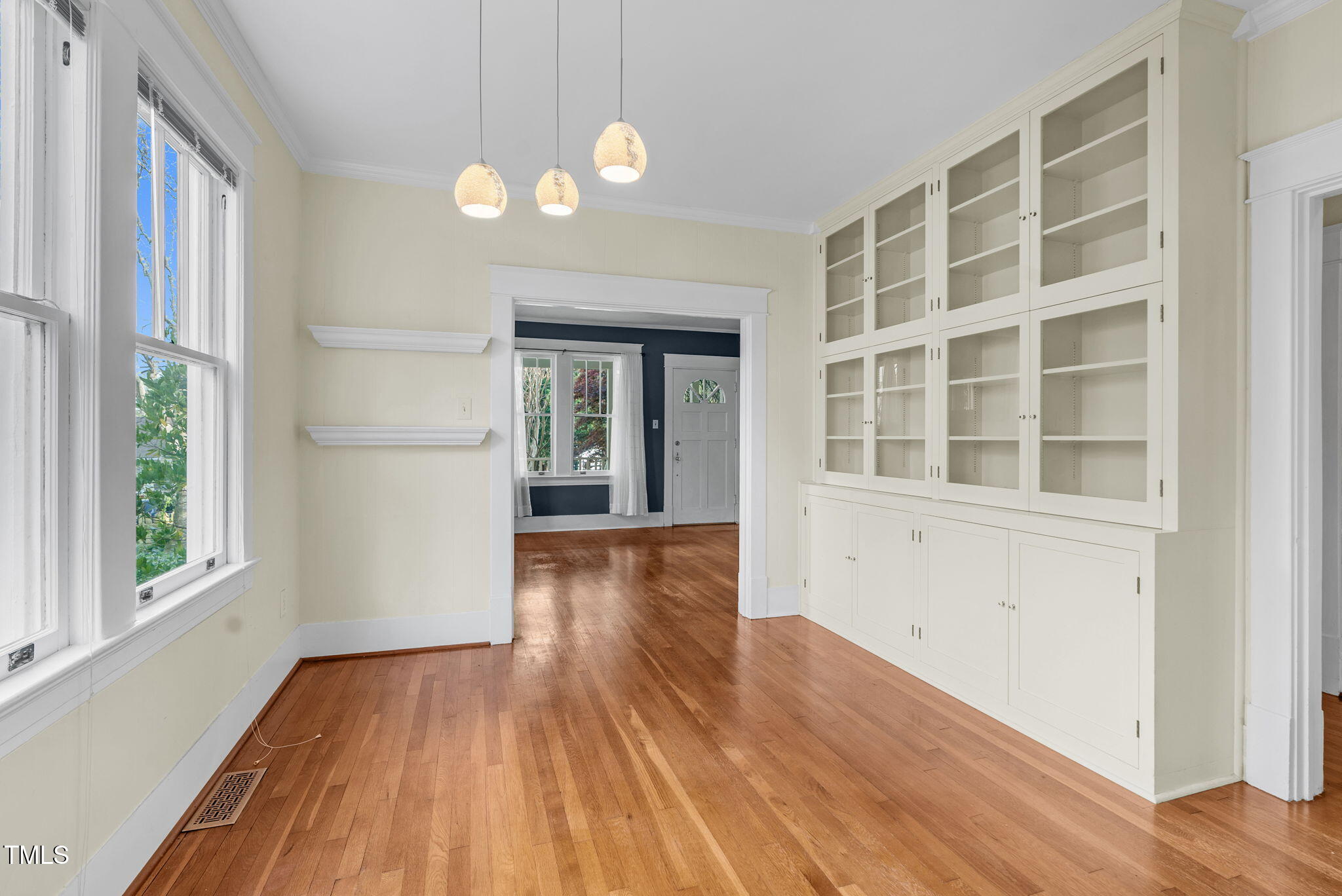 306 Perry Street Raleigh, NC 27608 - Photo 13 of 48 a view of an empty room with wooden floor and a window