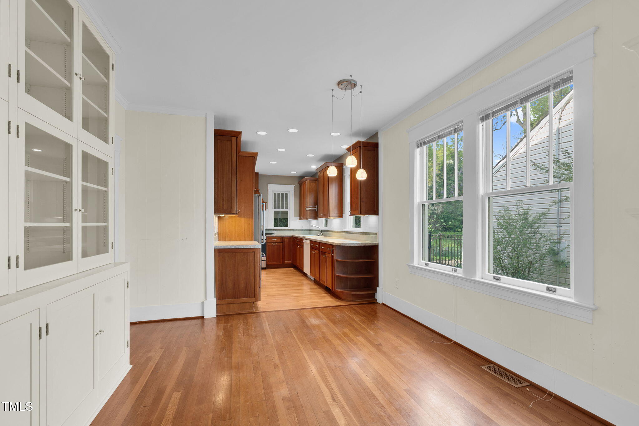 306 Perry Street Raleigh, NC 27608 - Photo 14 of 48 a view of large kitchen with stainless steel appliances wooden floor and cabinets