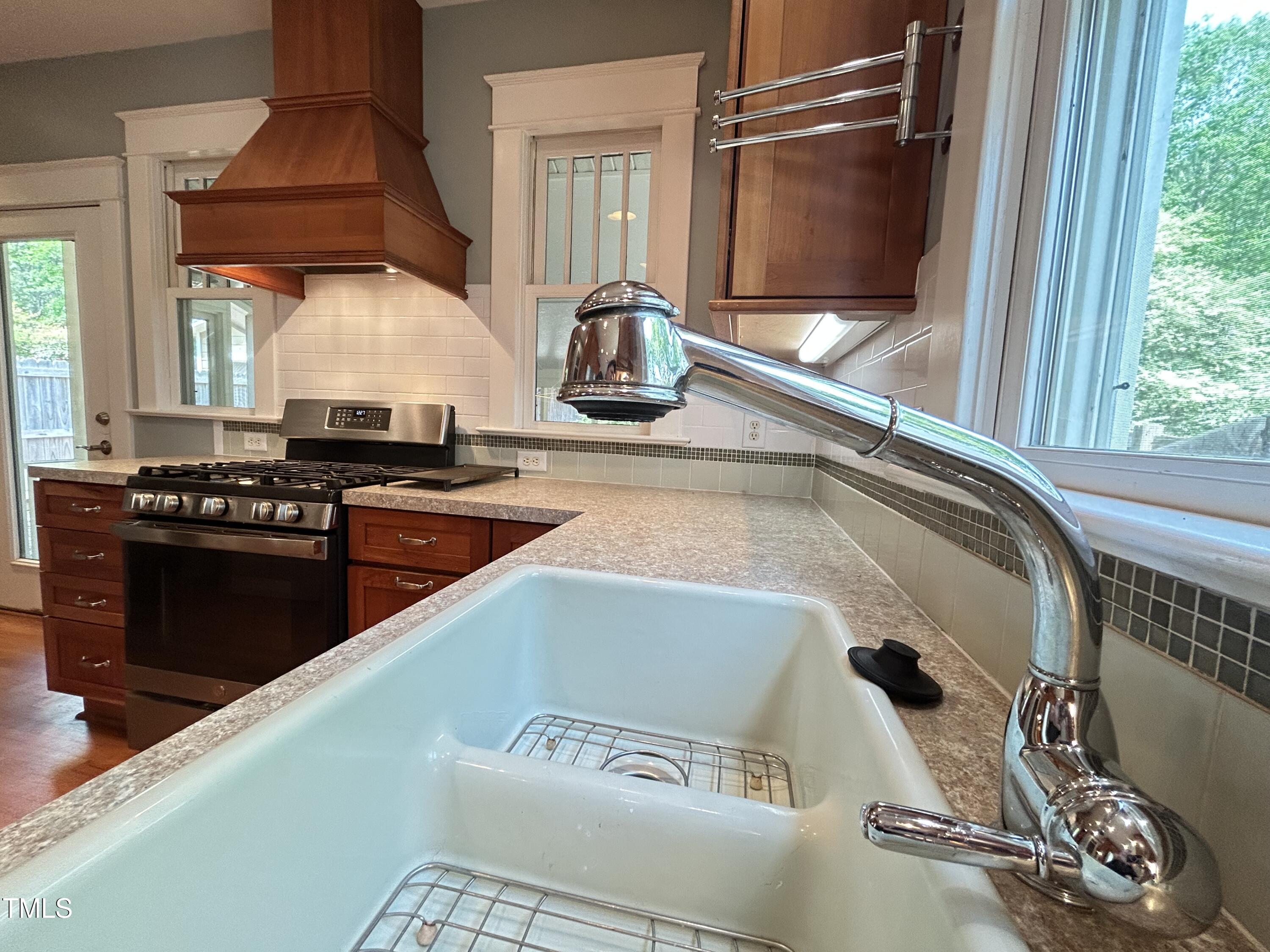 306 Perry Street Raleigh, NC 27608 - Photo 17 of 48 a kitchen with a sink a stove and a microwave