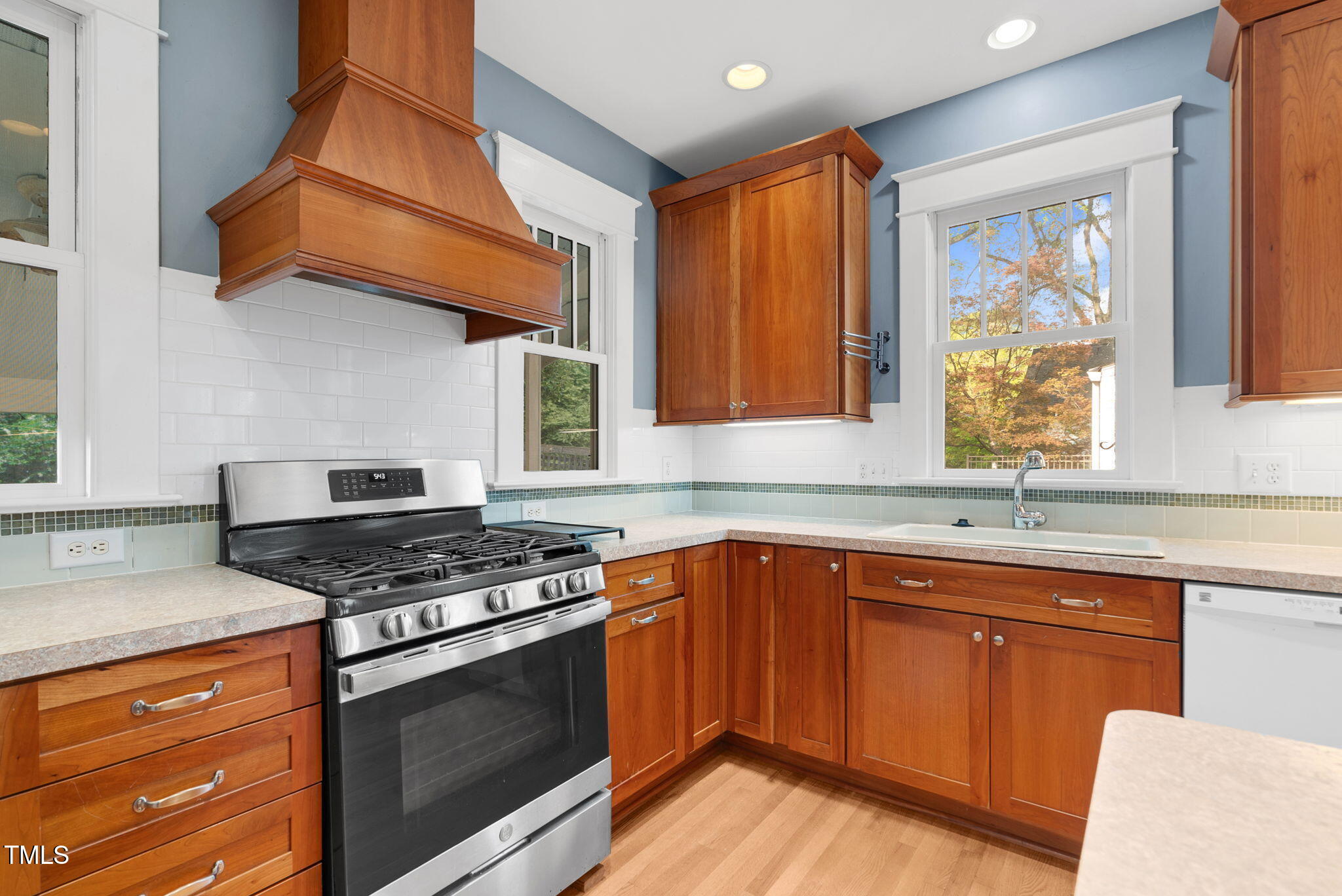306 Perry Street Raleigh, NC 27608 - Photo 19 of 48 a kitchen with stainless steel appliances granite countertop a stove a sink and a microwave