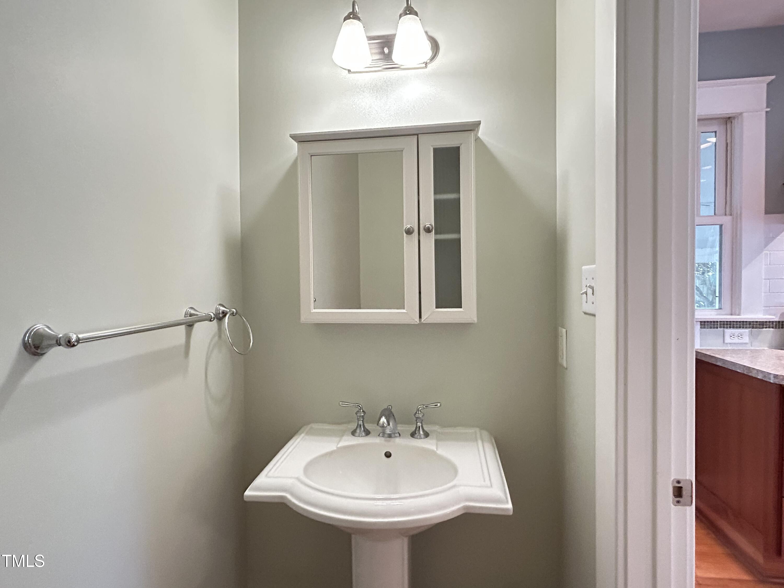 306 Perry Street Raleigh, NC 27608 - Photo 22 of 48 a bathroom with a sink and a mirror