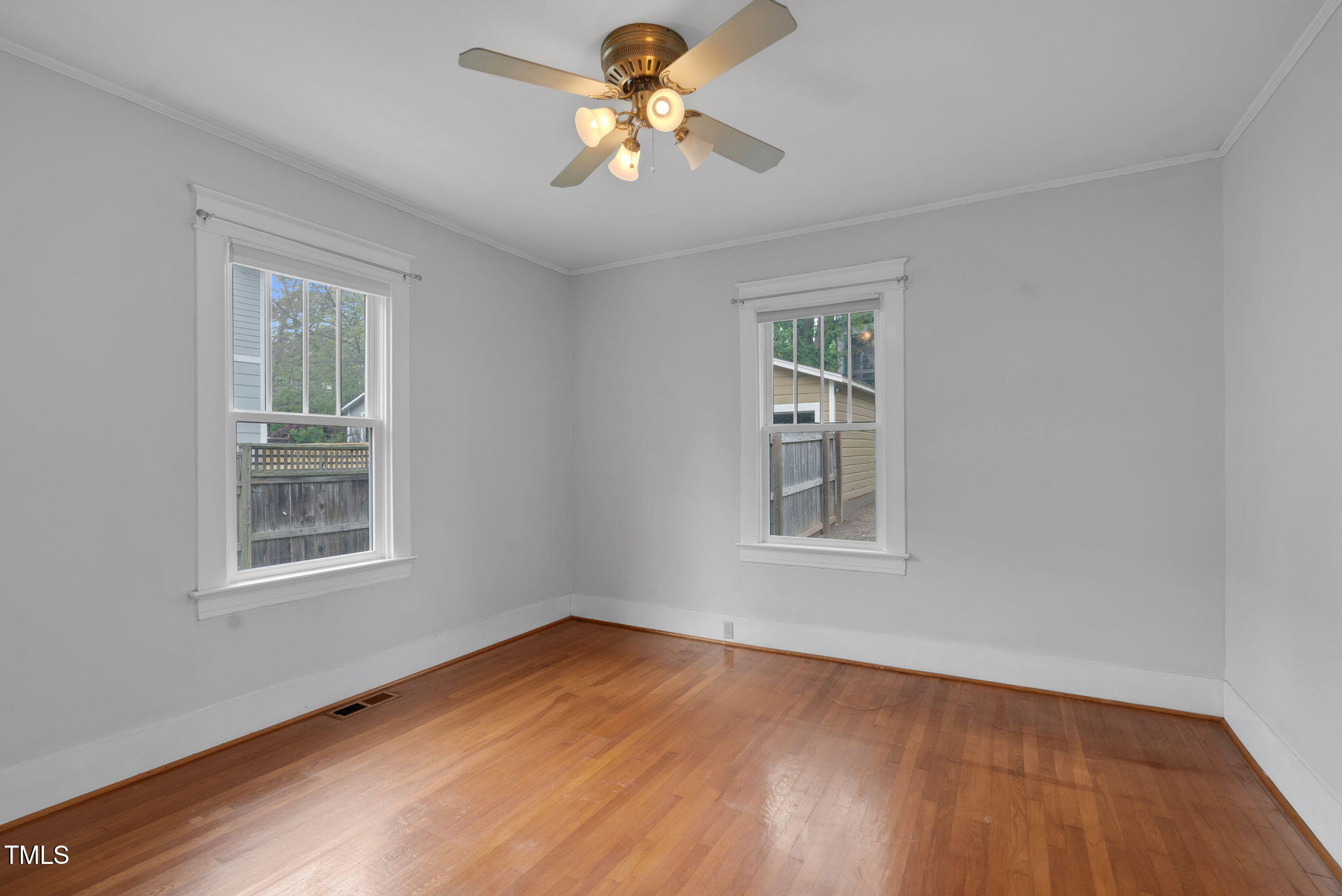 306 Perry Street Raleigh, NC 27608 - Photo 23 of 48 a view of empty room with wooden floor and fan