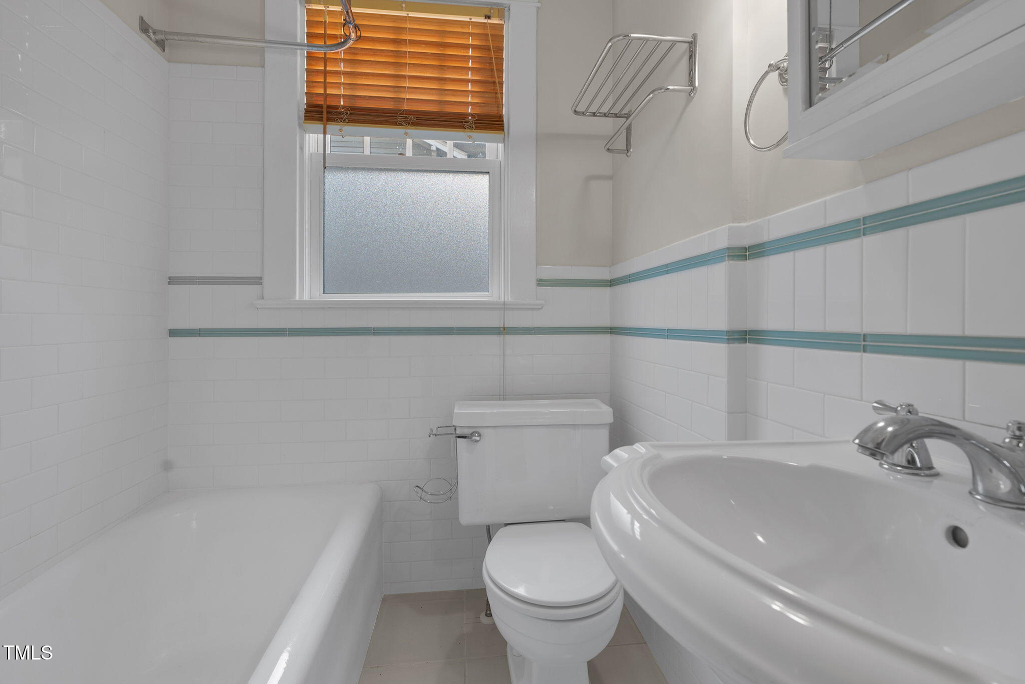 306 Perry Street Raleigh, NC 27608 - Photo 25 of 48 a bathroom with a sink and a bathtub