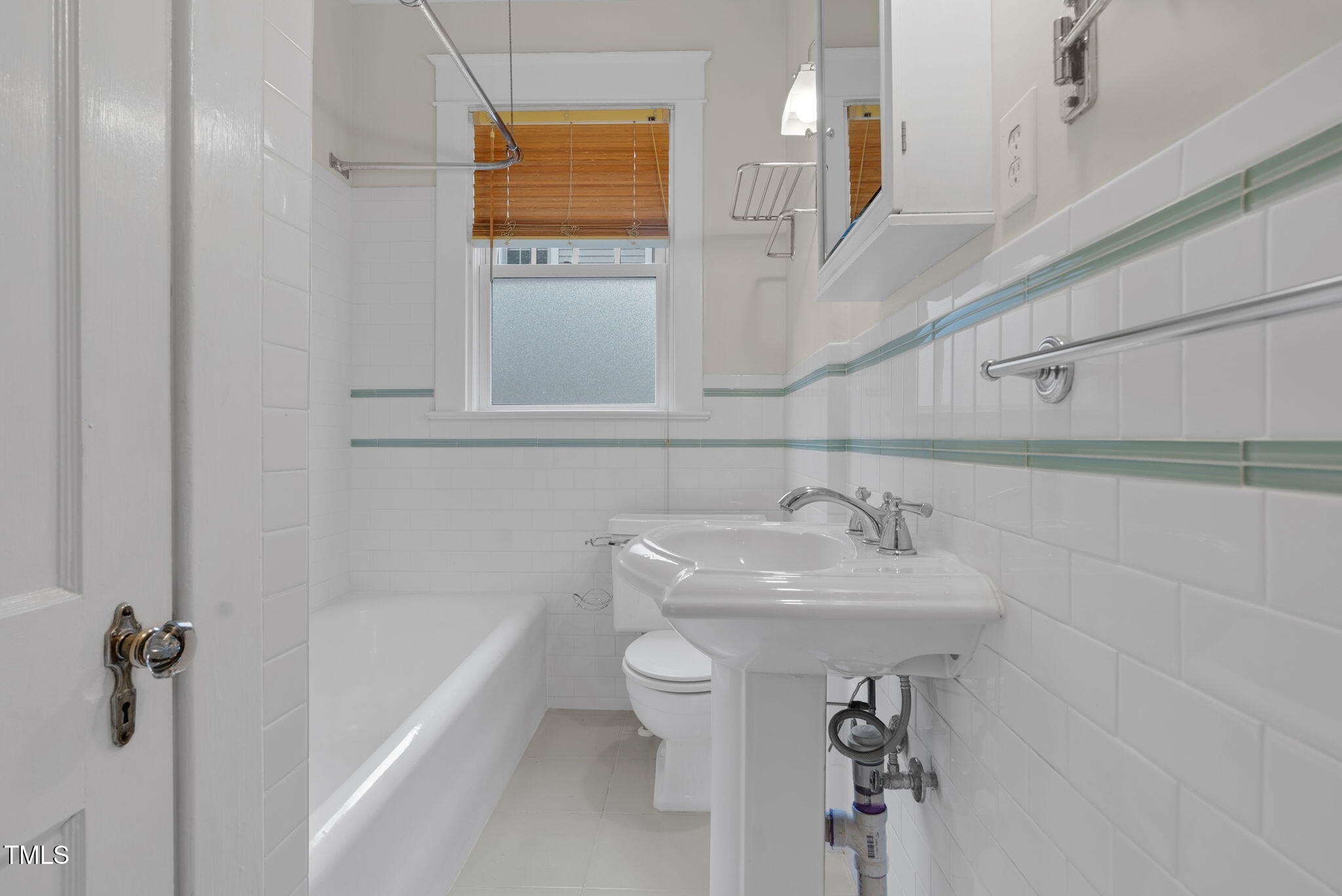 306 Perry Street Raleigh, NC 27608 - Photo 26 of 48 a bathroom with a sink a toilet and shower