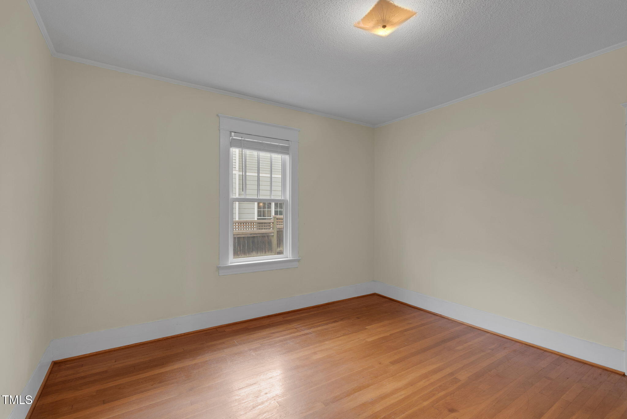 306 Perry Street Raleigh, NC 27608 - Photo 28 of 48 an empty room with wooden floor and windows