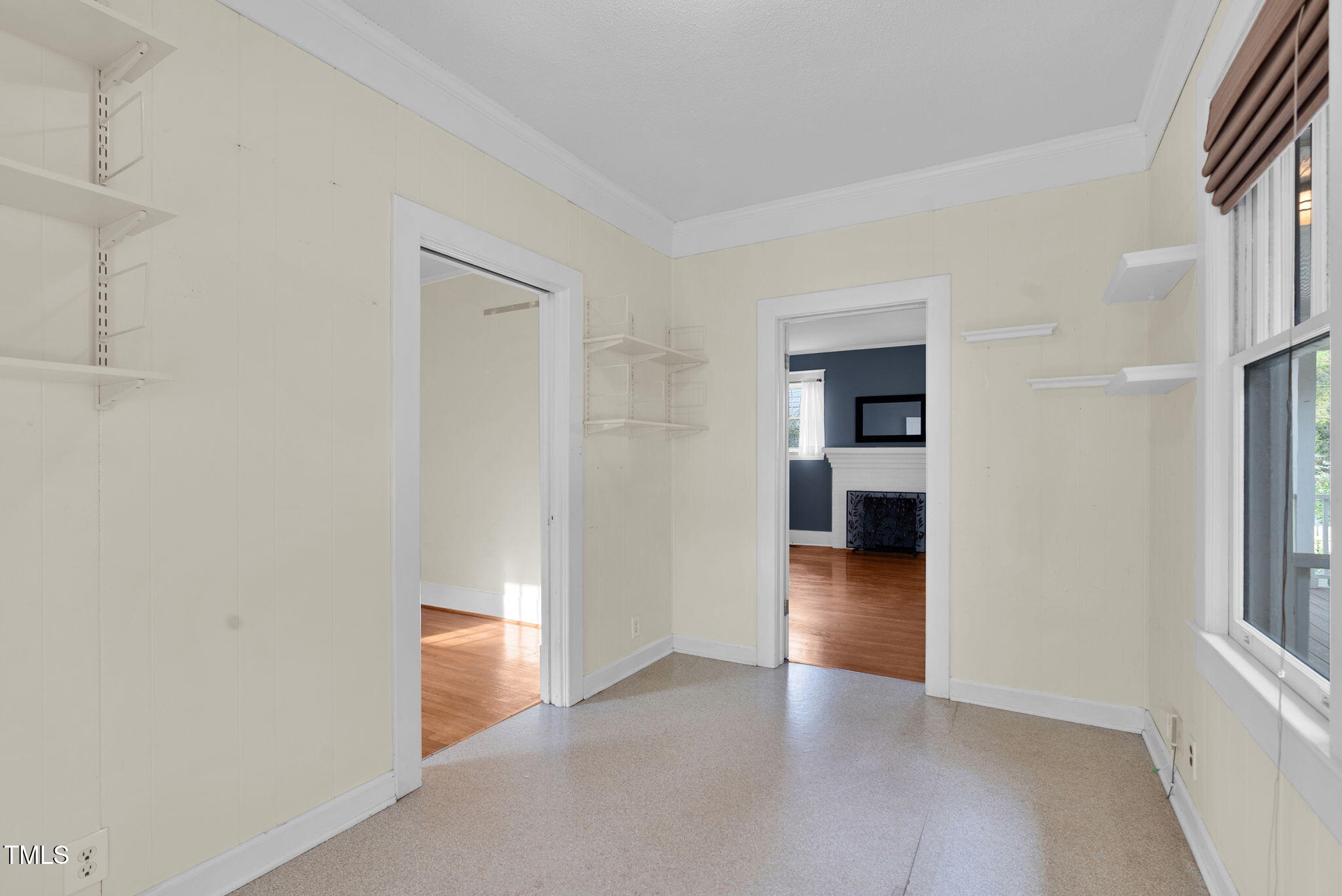 306 Perry Street Raleigh, NC 27608 - Photo 30 of 48 an empty room with wooden floor and a bathroom