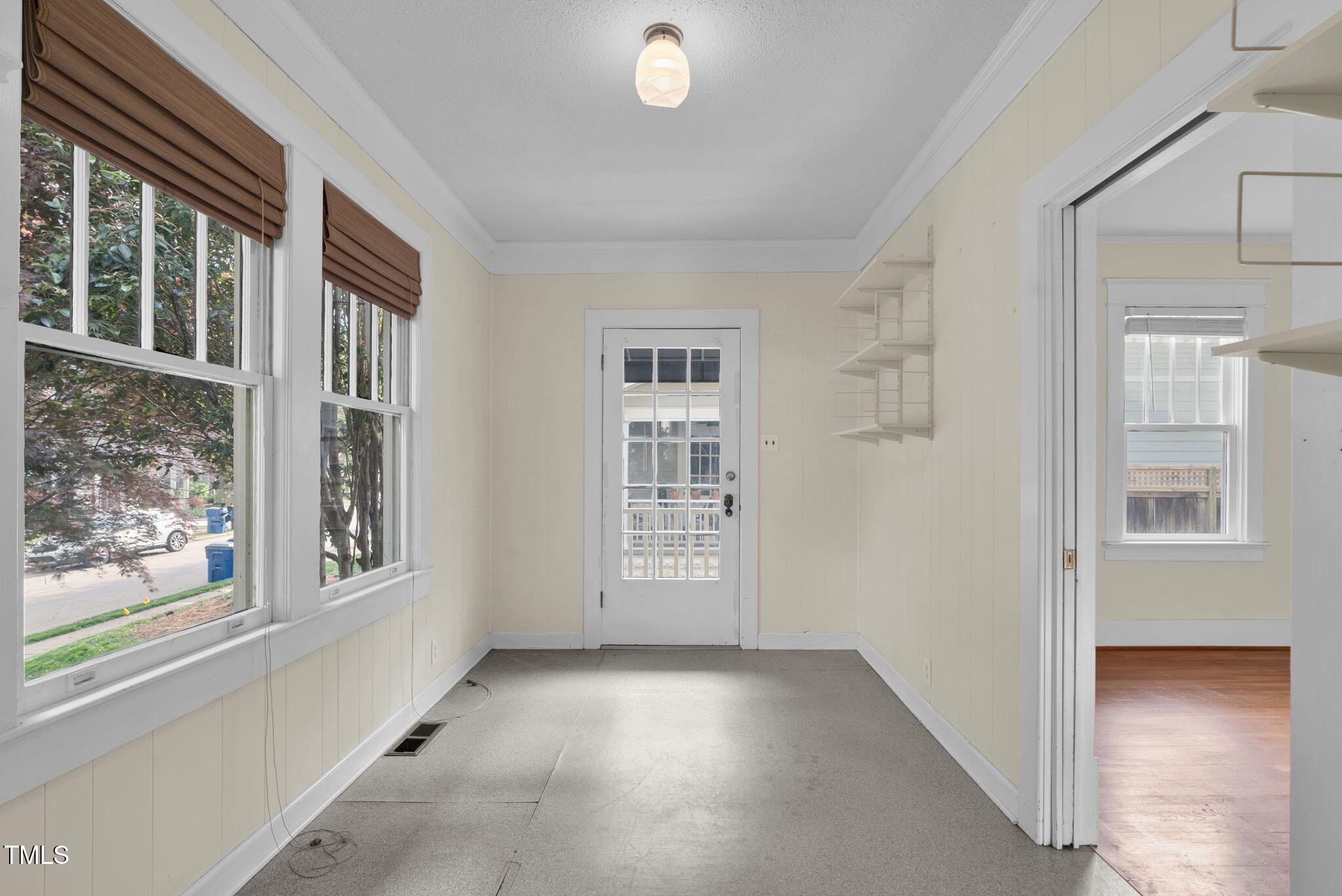 306 Perry Street Raleigh, NC 27608 - Photo 31 of 48 a view of an empty room with a window and wooden floor