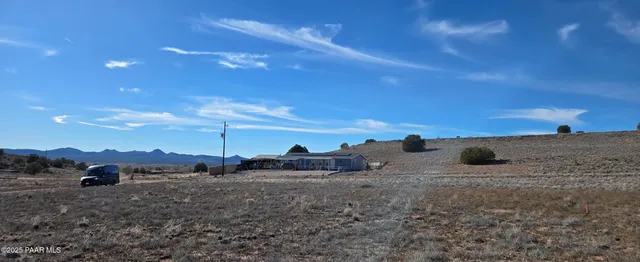 a view of ocean with a building in the background