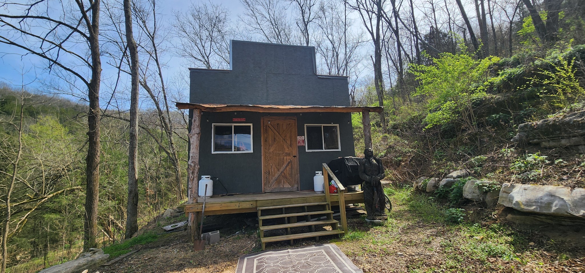 950 Chapman Hollow Road Dowelltown, TN 37059 - Photo 4 of 34 a view of a wooden bench under an umbrella