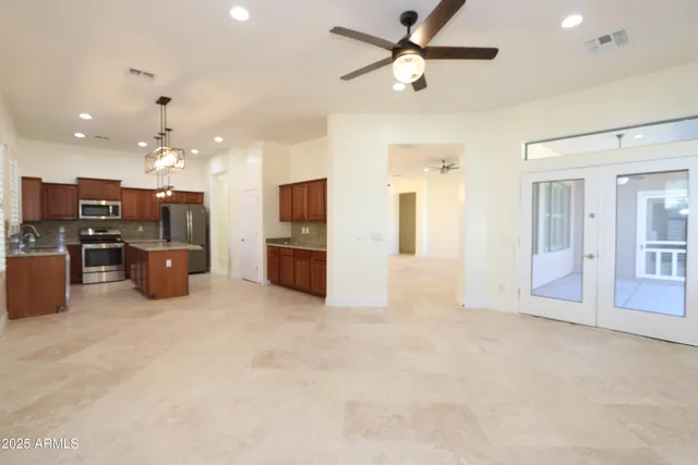 a living room with furniture and kitchen view