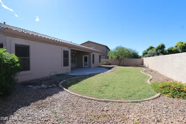 a view of a house with a backyard