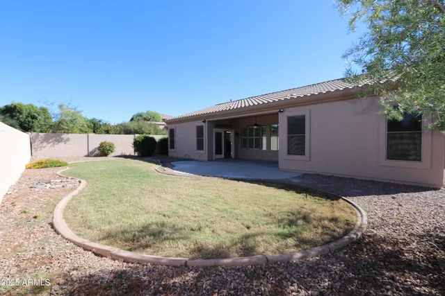 a view of a house with a backyard